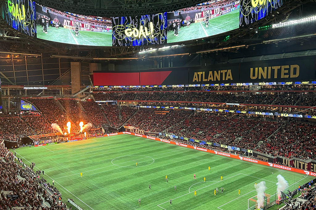 In the MLS Cup Playoffs, Atlanta United scores a goal, with fire in the background, against Columbus Crew at Mercedes Benz Stadium